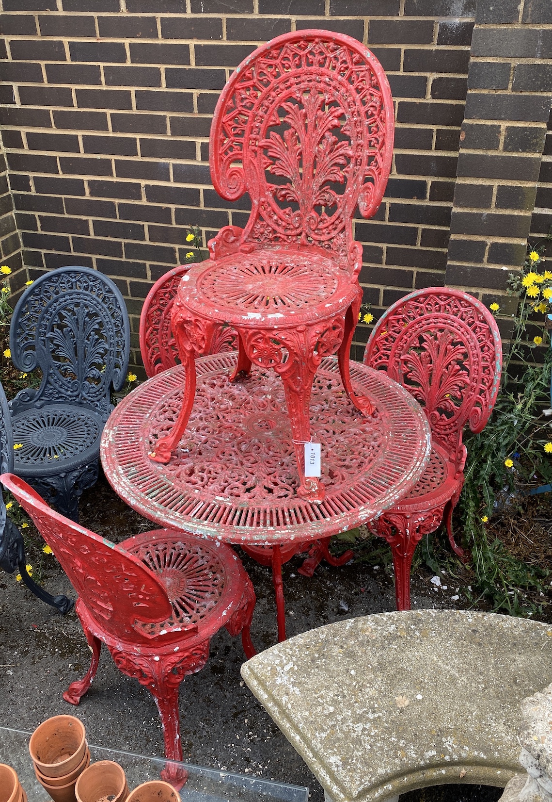 A Victorian style circular painted aluminium garden table, diameter 80cm, height 68cm and four chairs